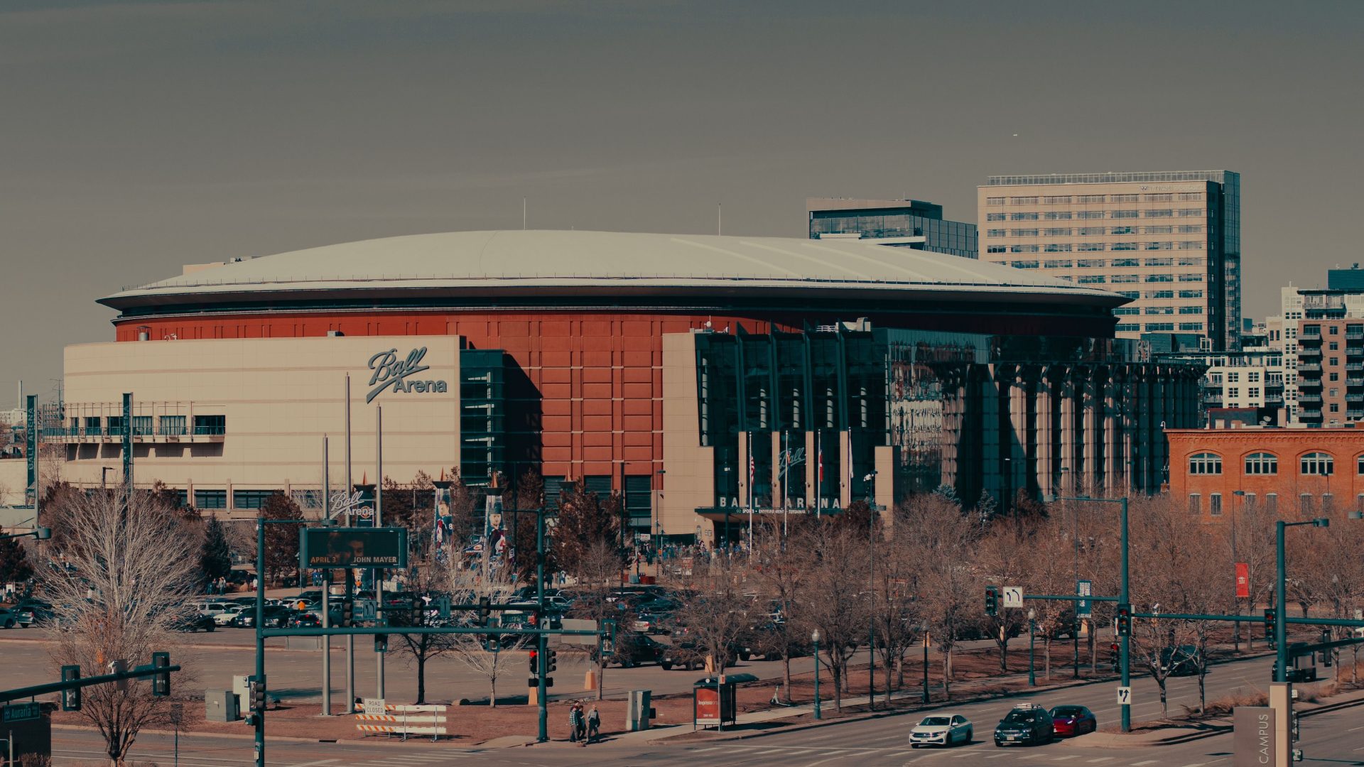A daylight view of Ball Arena amidst Denver's urban landscape, highlighting its architectural design.