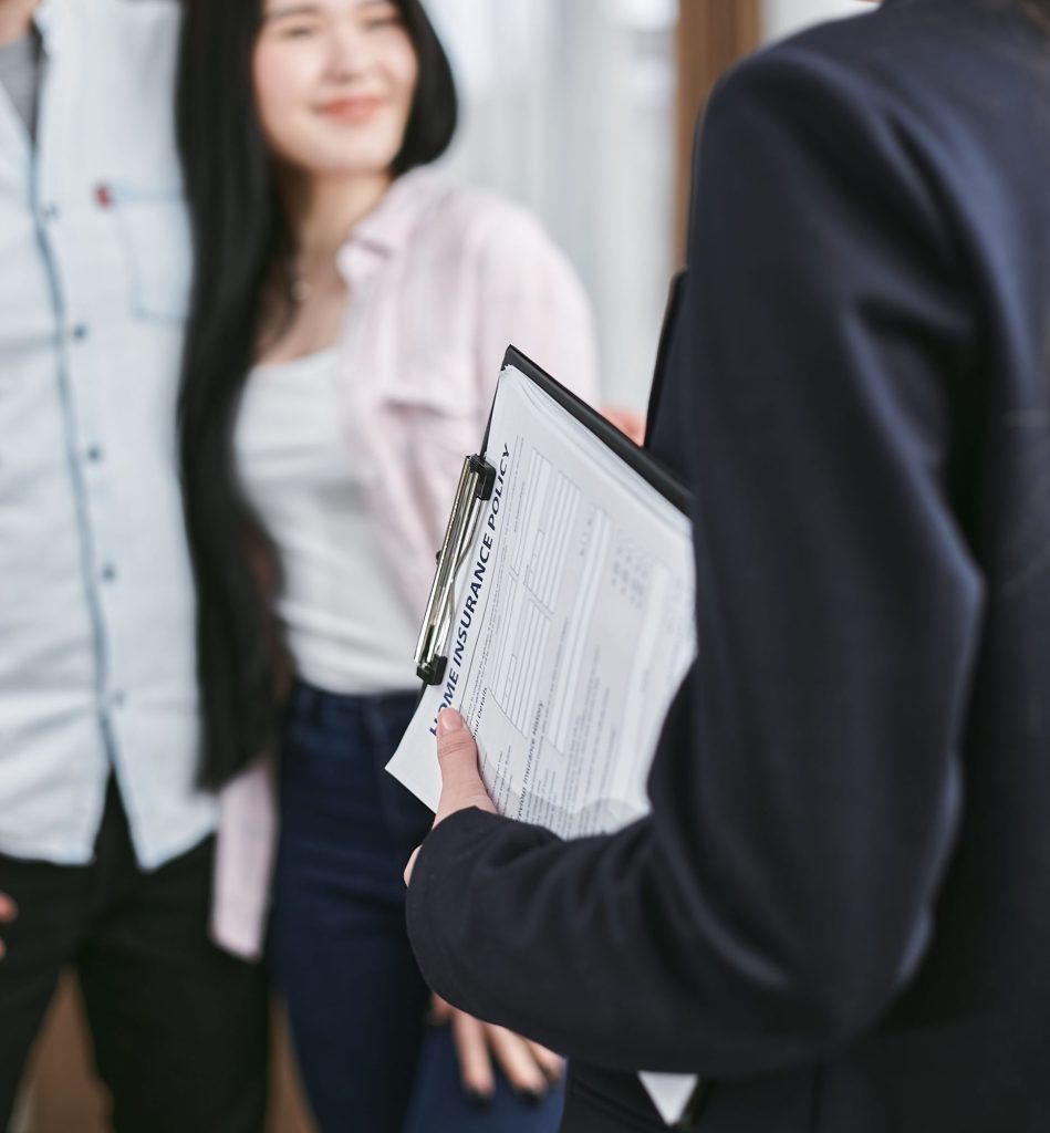 Professional meeting discussion with focus on business documents held by a woman.